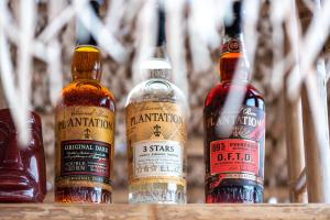 a group of four bottles of alcohol sitting on a table at Skinosummer in Paralia Agias Foteinis