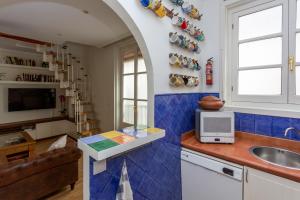 a kitchen with a sink and a counter with a microwave at Precioso dúplex en la Puerta del Sol. in Madrid