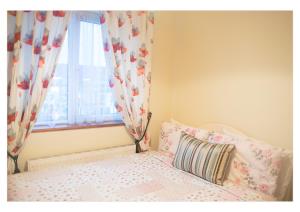 a small bedroom with a bed with a window at no 2 Leitrim Road in Carrick on Shannon