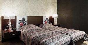 Postel nebo postele na pokoji v ubytování Hotel Cezaria