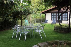 a table and chairs sitting on a lawn at Monte Baserria in Ziortza-Bolibar
