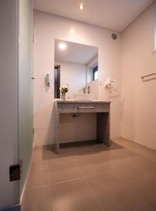 a bathroom with a sink and a mirror at Villa Caparica Hostel in Costa da Caparica