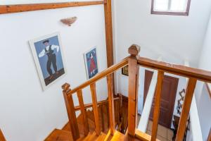 a staircase with two pictures of a man on the wall at Villa Ponente in Spetses