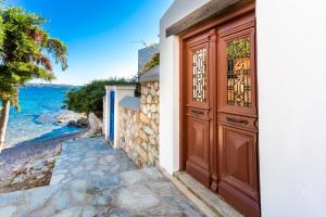 a door to a house with a view of the ocean at Villa Ponente in Spetses