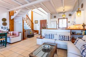 a living room with a couch and a table at Villa Ponente in Spetses