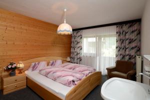 Uma cama ou camas num quarto em Gästehaus Riml