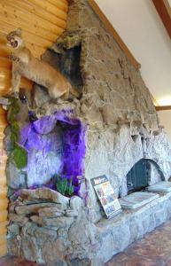 una chimenea de piedra con un oso encima en Bryce Canyon Resort, en Bryce Canyon