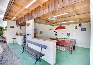 a room with a pool table and a bench at Tan y Garth in Denbigh