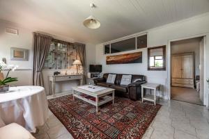 salon z kanapą i stołem w obiekcie Garden apartment Bay View w Kapsztadzie