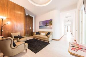 a living room with two couches and a table at M&F Apartaments Gran Via in Madrid