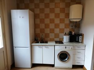 a kitchen with a refrigerator and a washing machine at Donostia Apartment Parking Included in San Sebastián