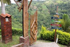a wooden gate with a bunch of street signs at Hotel Boutique Villa María in Vergara
