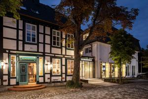 a black and white building with a tree in front at WunnersWat Verl in Verl