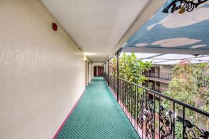 a corridor of a building with a balcony at OYO Townhouse Tulsa Woodland Hills in Tulsa