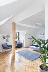 a living room with a bed and a blue rug at Opera Apartments in Poznań