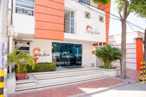 a building with an orange and white facade at Hotel NelyMar in Santa Marta