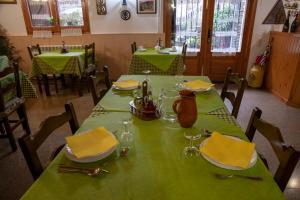 a green table with yellow napkins and glasses on it at Casa Rural Besolí in Areu