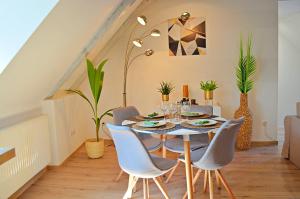 uma sala de jantar com mesa e cadeiras em La pause gourmande charme et confort au centre ville em Molsheim