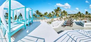 una cubierta de un crucero con palmeras en Dream Punta Cana Beachfront Apartment - 4-Bedroom Penthouse with Rooftop BBQ & Ocean Views, en Punta Cana