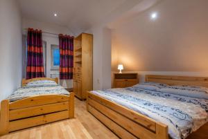 Postel nebo postele na pokoji v ubytování A&A Apartmany
