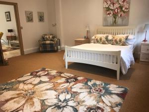 a bedroom with a white bed and a rug at Grey Oak in Newark-on-Trent