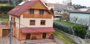 a house with a red roof on top of it at Ubytování Na Vyhlídce 143 in Benátky nad Jizerou