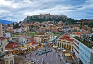 a view of a city with a hill in the background at Cozy Studio, Athens city center in Athens