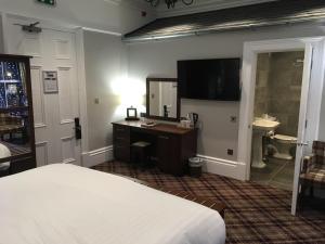 a hotel room with a bed and a desk at The Portree Hotel in Portree