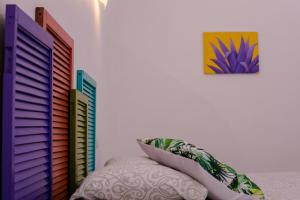 a bedroom with a blue wall and a blue bedspread at Vainilla Bed and Breakfast Mexico in Playa del Carmen