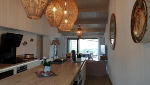 a kitchen with a counter and some lights and a table at Rélocation vacances de la cote sauvage in Saint-Clément-des-Baleines