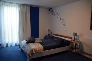 ein Schlafzimmer mit einem Bett mit blauen Laken und einem Fenster in der Unterkunft Ferienwohnung Marosa in Willingen