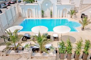 an overhead view of a swimming pool with umbrellas at Villa Le Premier in Odesa