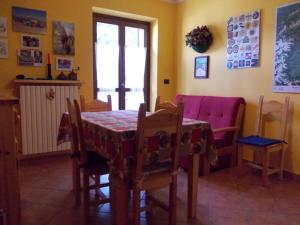 a dining room with a table and chairs and a table and a table at Casa Grande in Pragelato
