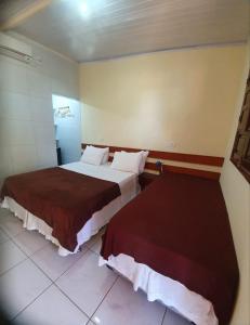 a hotel room with two beds in a room at Casa do Maneco in Fernando de Noronha +28 photos