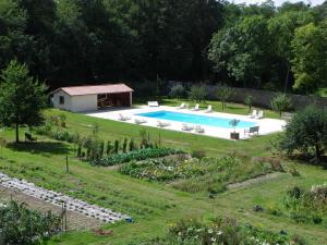 an image of a swimming pool in a garden at Château de la Marronnière in Aizenay