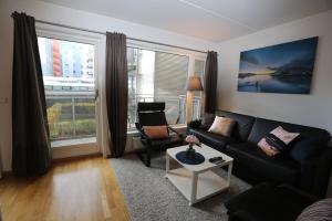 a living room with a couch and a table at OSLO CITY CENTER 3 BEDROOMS APARTMENT, MANDALLS GATE 12 in Oslo
