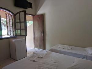A bed or beds in a room at Pousada Canto do Rio