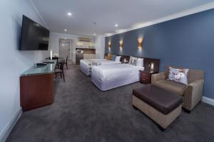 a hotel room with a bed and a living room at Hyde Park Inn in Sydney +37 photos