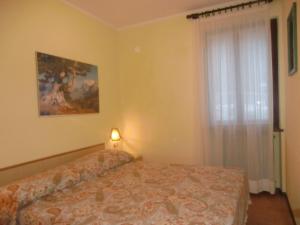 a bedroom with a bed and a window at Appartamento Belvedere in Molina di Ledro