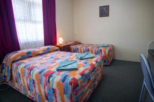 a hotel room with two beds and a window at Murray Bridge Motor Inn in Murray Bridge