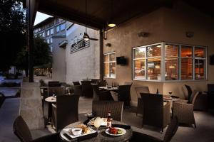 a restaurant with tables and chairs in front of a building at Holiday Inn San Antonio Northwest- SeaWorld Area, an IHG Hotel in San Antonio