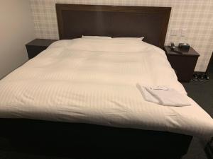Voodi või voodid majutusasutuse Nagoyaeki Access Hotel toas
