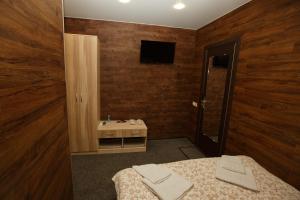 a bathroom with a bed and a sink and a mirror at OVB Hostel in Ob