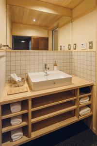 a bathroom with a sink and a mirror at Someno House Kyoto Dog Friendly in Kyoto