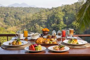 a table topped with plates of food on top of a mountain at Ayung Resort Ubud in Payangan