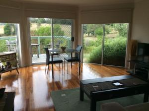 sala de estar con mesa, sillas y puertas correderas de cristal en Forrest River Valley, en Forrest