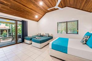 a bedroom with two beds and a balcony at Heron Island in Heron Island