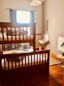 a bedroom with a bunk bed and a sink at HarbourView Hotel in Raglan