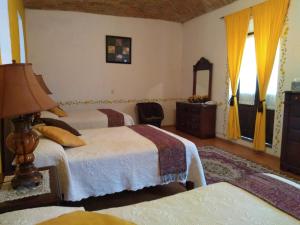 Postel nebo postele na pokoji v ubytování Hotel Spa Hacienda Real la Nogalera