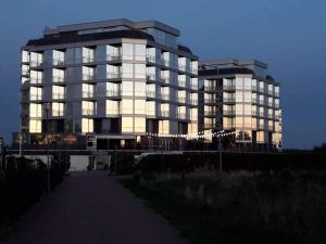 a large building with the sun shining on it at Elijos apartamentai in Šventoji